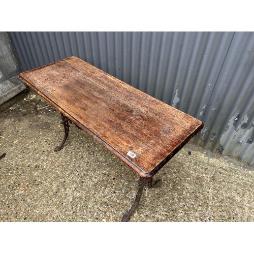 118 - A rectangular cast iron based table with mahogany top  120x50x74