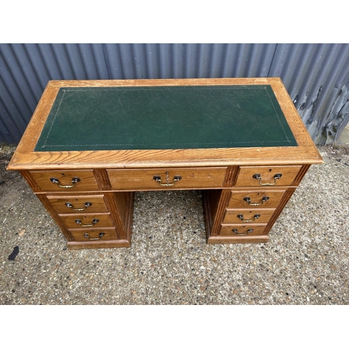 126 - An early 20th century oak twin pedestal desk with green leather top