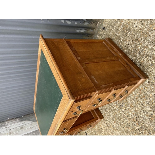 126 - An early 20th century oak twin pedestal desk with green leather top