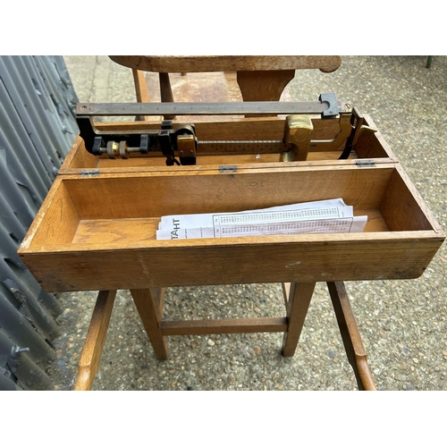 127 - A 20th century oak JOCKEY SCALE seated weighing scales