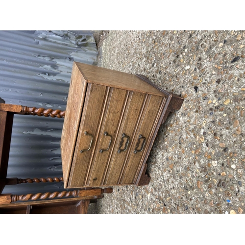 133 - A slim oak bookcase, together with barley twist table and a small canteen chest