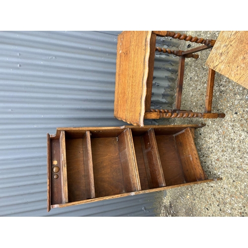 133 - A slim oak bookcase, together with barley twist table and a small canteen chest