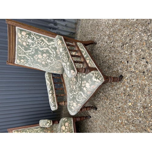 135 - A pair of Edwardian oak framed chairs with green pattern upholstery