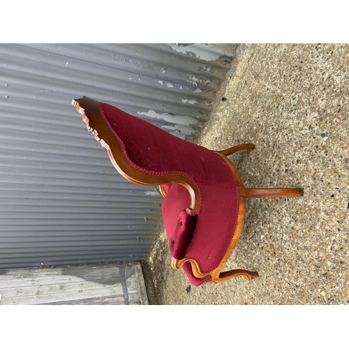 15 - A mahogany framed bedroom chair with red button upholstery