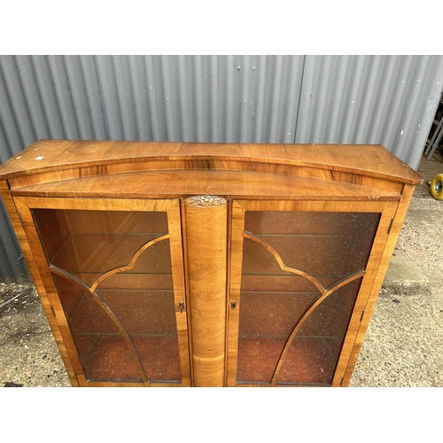 16 - An art deco walnut two door glazed display cabinet 118x30x120