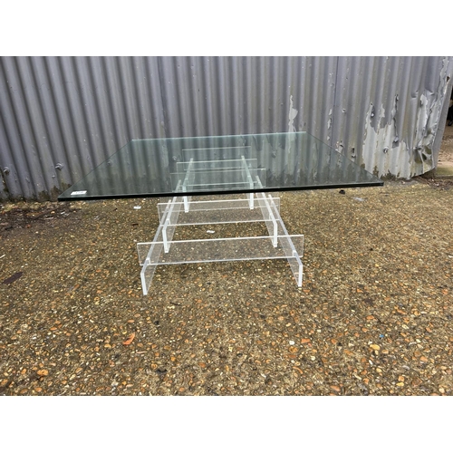 178 - A modern thick glass square coffee table with Perspex support