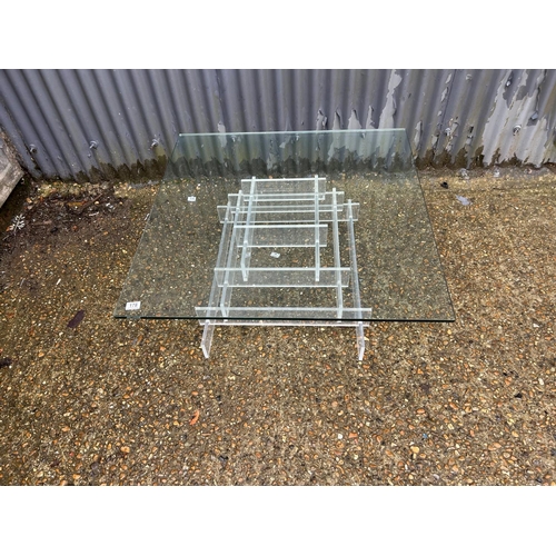 178 - A modern thick glass square coffee table with Perspex support