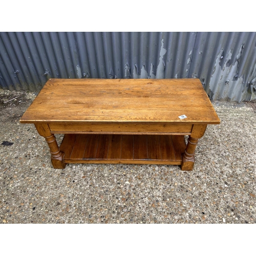 18 - A reproduction oak coffee table with storage 100x 45 x47