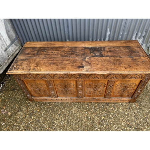 201 - A very large carved oak four panel blanket box 160x65x65