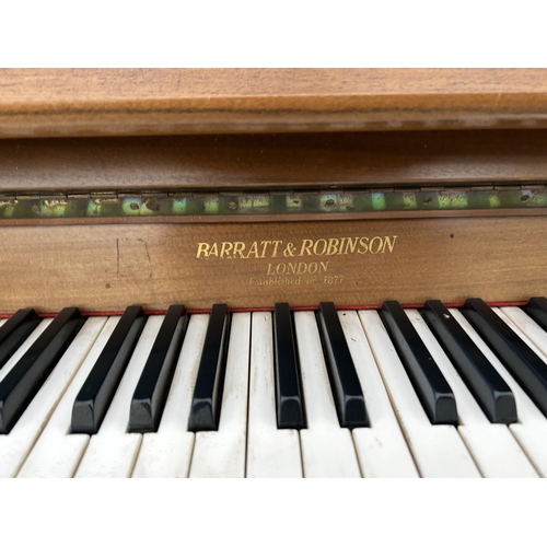 262 - A mid century teak cased upright piano by BARRET AND ROBINSON 134cm wide