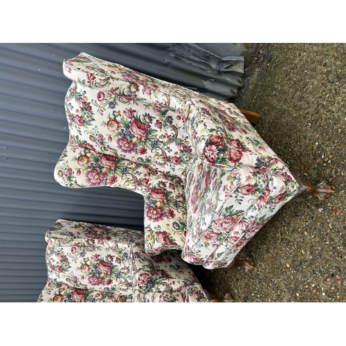 299 - A pair of floral unholstered wing back armchairs with ball and claw feet