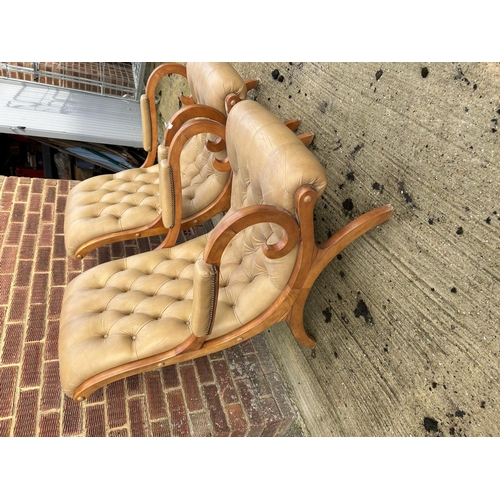 311 - A pair of gold coloured leather chesterfield slipper chairs