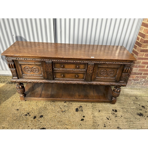 313 - A Jacobean style carved oak sideboard 168x 48 x90