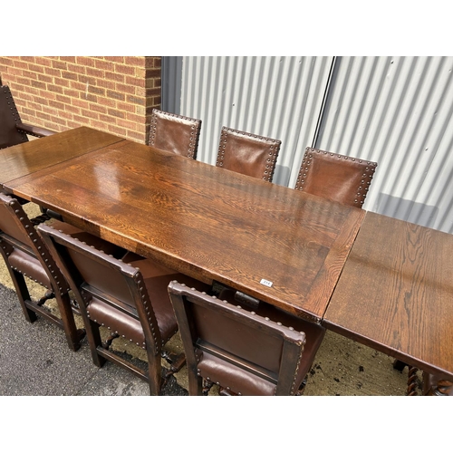 314 - Jacobean style oak drawer leaf dining table together with a set of 8 leather and brass studded oak c... 