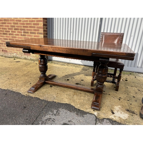 314 - Jacobean style oak drawer leaf dining table together with a set of 8 leather and brass studded oak c... 