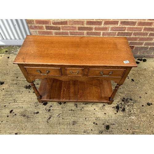 315 - An oak three drawer lowboy / serving table 96x38x77