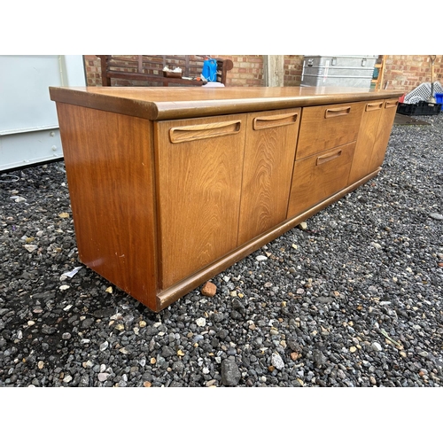 324 - A low teak sideboard / base unit