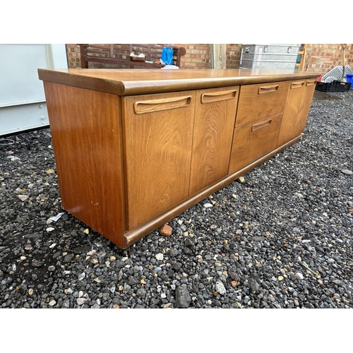 324 - A low teak sideboard / base unit