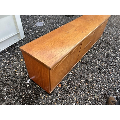 324 - A low teak sideboard / base unit