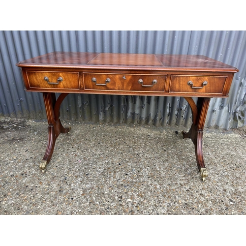 33 - A reproduction mahogany three drawer writing table 120x60x77