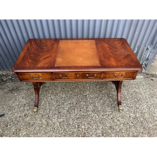 33 - A reproduction mahogany three drawer writing table 120x60x77