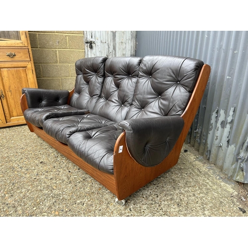 4 - A g plan teak framed three seater sofa with brown leather cushions