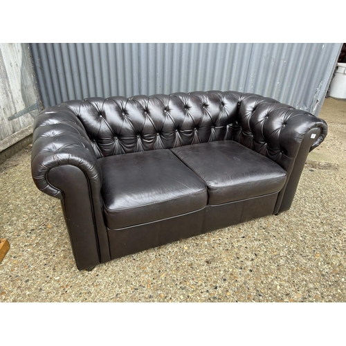 5 - A dark brown leather two seater chesterfield sofa 164cm wide