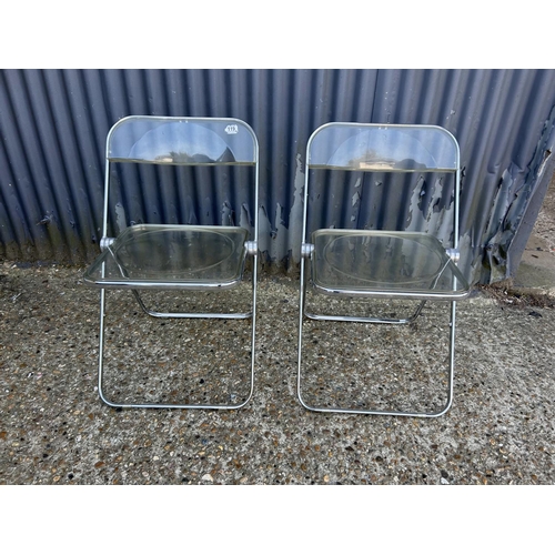 63 - A pair of Italian designer chrome and Perspex folding chairs by CASTELLI