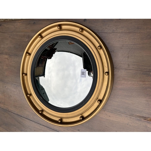 80 - A gold gilt convex mirror