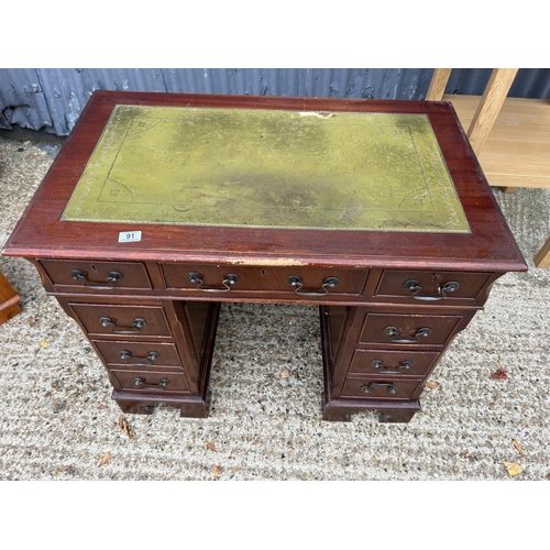 91 - A small reproduction mahogany twin pedestal desk