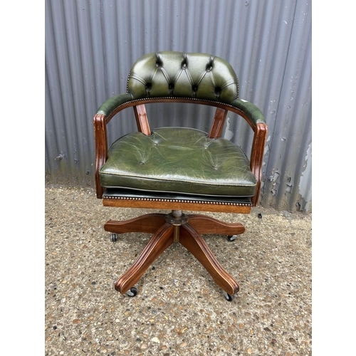 1 - A green leather swivel captains style desk chair