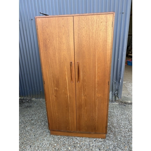 56 - A g plan fresco gents double wardrobe, fitted to the interior