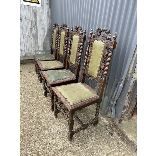 14 - A set of four French oak dining chairs with barley twist and carved backs