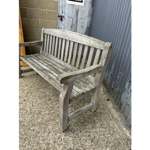 17 - A good quality weathered wooden garden bench seat 124 cm wide