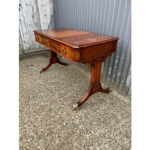 33 - A reproduction mahogany three drawer writing table 120x60x77