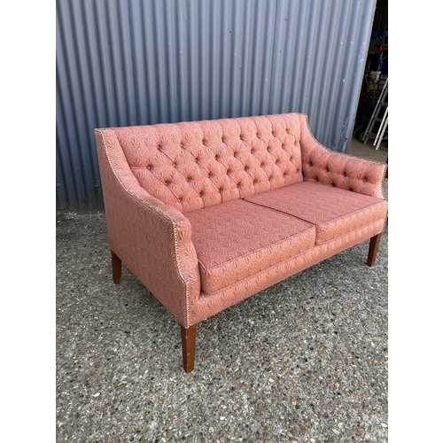 62 - A red upholstered button back love seat