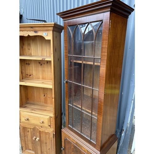 79 - A tall slim pine bookcase together with a slim mahogany bookcase