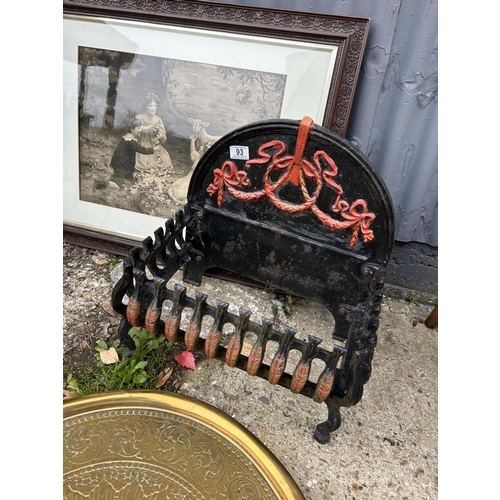 93 - An iron fire basket, lamb print and two brass trays