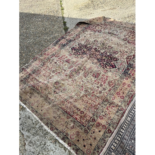 108 - Worn red and gold patterned rug together with grey pattern rug