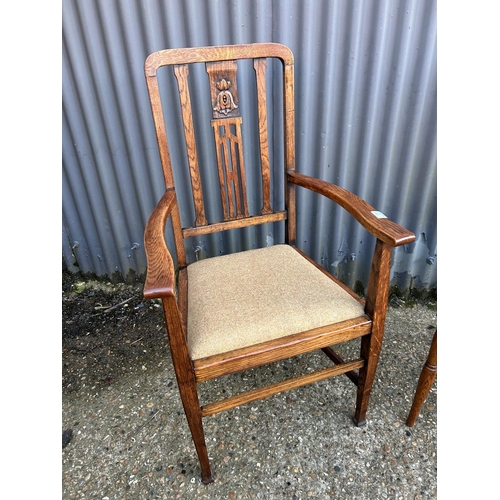 12 - Two early 20th century oak chairs upholstered in tweed patterns