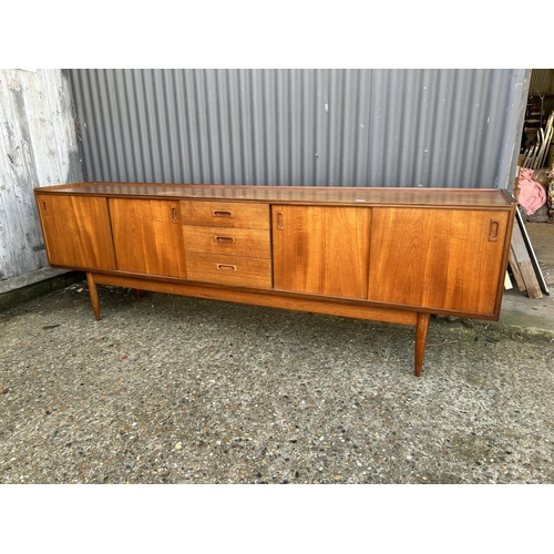 124 - Mid century Danish style Teak sideboard with 4 sliding doors and three drawers, 232 x 43 x 75cms