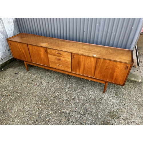 124 - Mid century Danish style Teak sideboard with 4 sliding doors and three drawers, 232 x 43 x 75cms