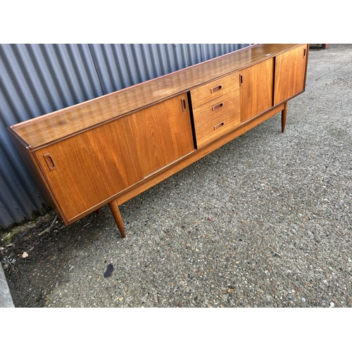 124 - Mid century Danish style Teak sideboard with 4 sliding doors and three drawers, 232 x 43 x 75cms