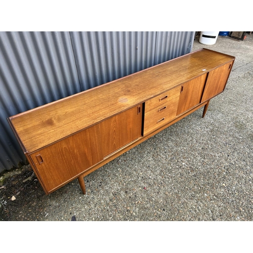 124 - Mid century Danish style Teak sideboard with 4 sliding doors and three drawers, 232 x 43 x 75cms