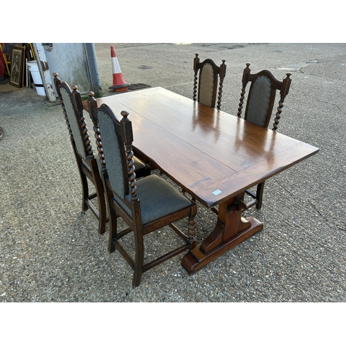 15 - An oak refectory style dining table together with four oak barley twist dining chairs, recently upho... 