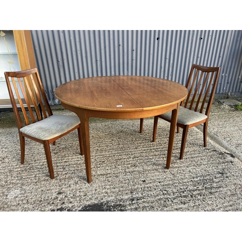 156 - Nathan teak circular dining table together with 2 G plan teak dining chairs