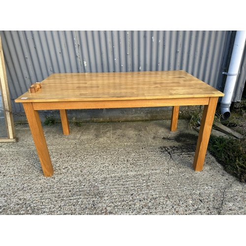 158 - A modern oak dining table 151 x 92cms