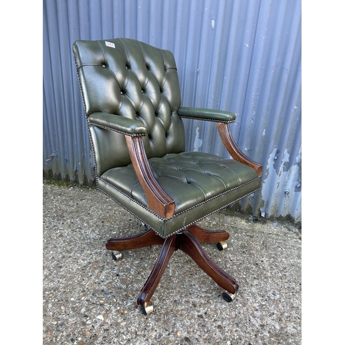 163 - A green Chesterfield buttoned leather swivel desk chair