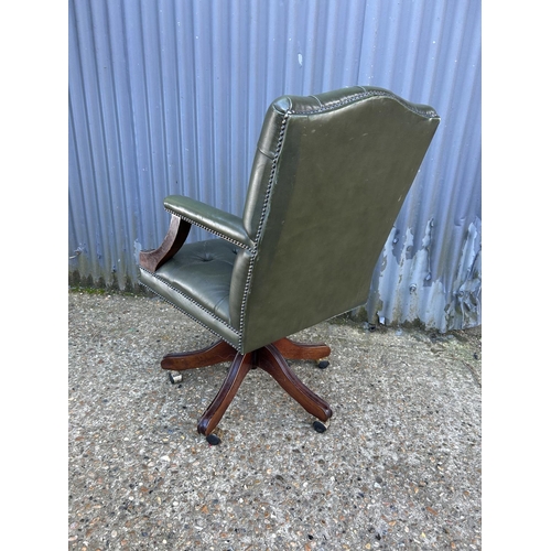 163 - A green Chesterfield buttoned leather swivel desk chair