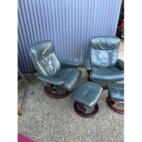 164 - A pair of green leather Ekornes stressless reclining chairs with footstools